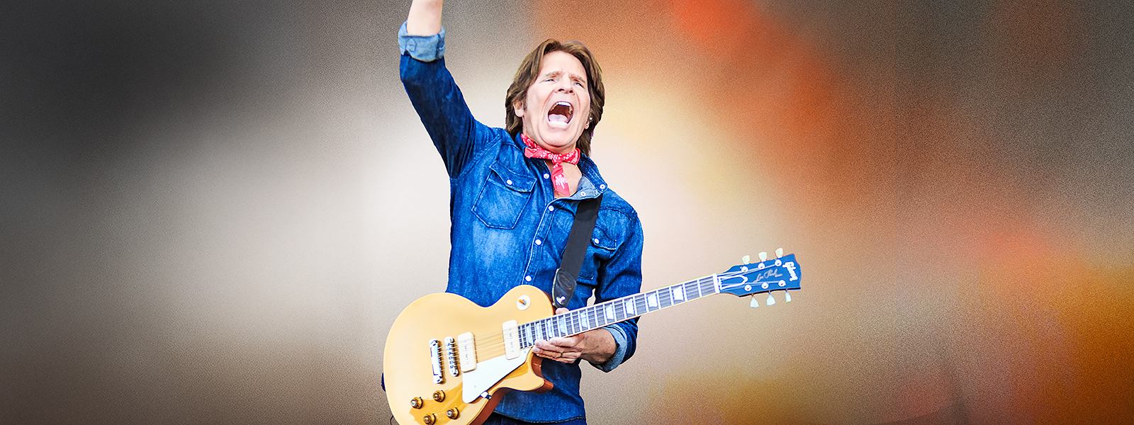 excited man holding a guitar
